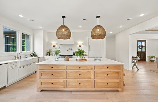 kitchen island, storage drawers, pendant lights, recessed lighting, sink, cabinets, Gas Range, Pot filler, Hardwood Flooring, Marble Countertops