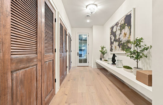 mud room, storage closets, hardwood flooring