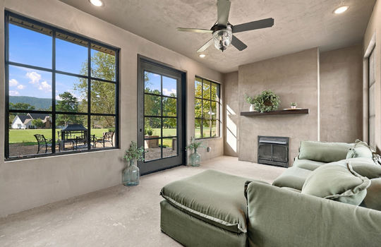 sunroom, fireplace, ceiling fan, windows, exterior door to side yard