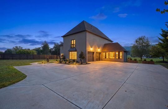driveway view of home, side view of home, two car garage, landscaping, concrete driveway, fencing
