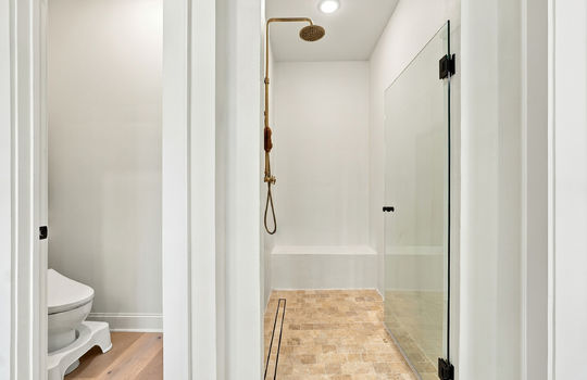 bathroom, shower, water closet, tile flooring, hardwood flooring, glass shower door