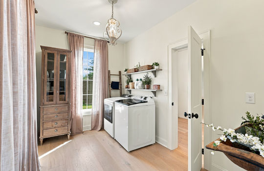 Laundry room, washer/dryer hookups, hardwood flooring, window, shelving
