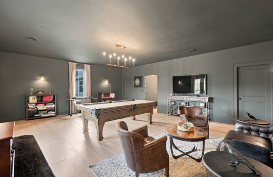 game room, hardwood flooring, chandelier, windows