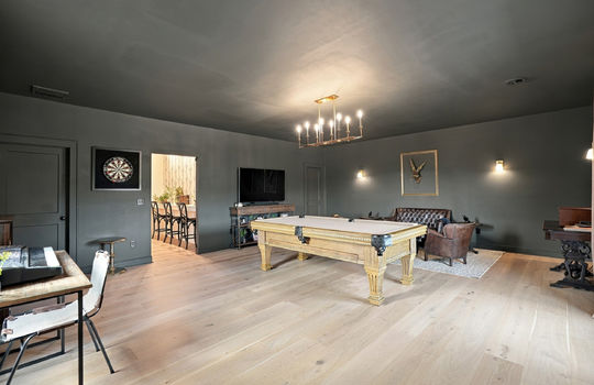 game room/speak easy, hardwood flooring, chandelier