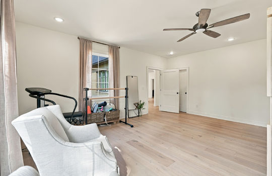 bedroom/fitness room, hardwood flooring, ceiling fan, recessed lighting, windows