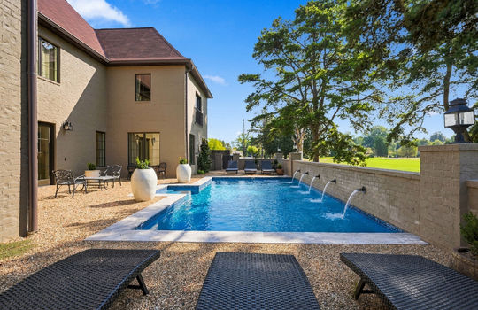 back yard, in-ground heated pool, landscaping, brick exterior, exterior doors