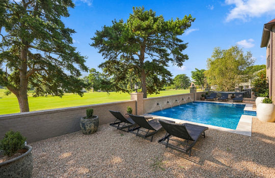 back yard, landscaping, in-ground heated pool, brick wall