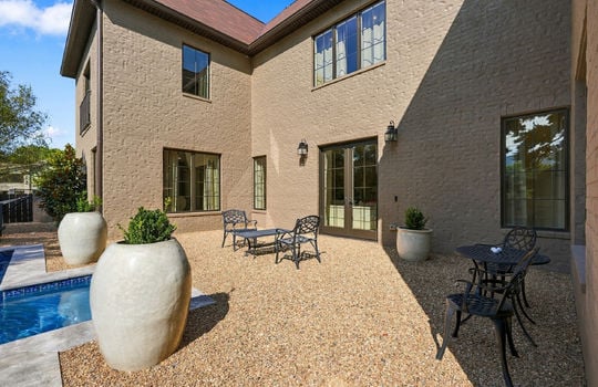 back yard, exterior entry door, brick exterior, windows