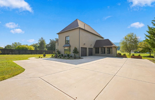 driveway view of home, brick exterior, concreted driveway, two car garage, garage doors, landscaping, yard