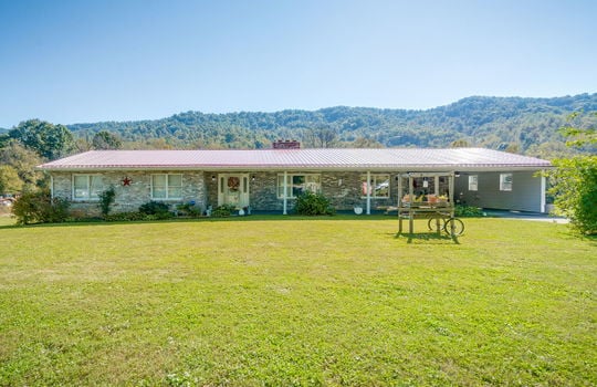 brick ranch, front yard, covered front porch, carport, metal roof, front door, windows, mountain views