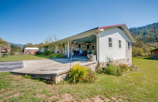 right side view of home, carport, driveway, side yard, covered front porch, brick, ranch, mountain views