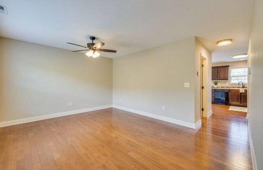 living room, hardwood flooring, ceiling fan, view toward kitchen