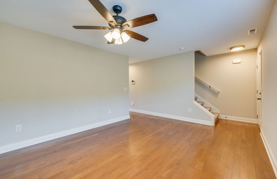 living room, hardwood flooring, front door, stairs, ceiling fan