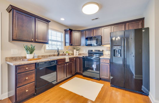 kitchen, cabinets, countertops, sink, dishwasher, built-in microwave, oven/range, refrigerator, hardwood flooring