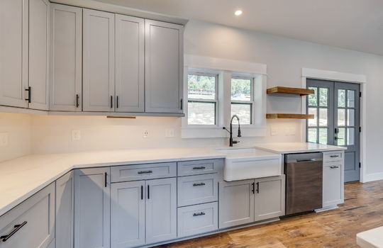 kitchen, countertops, cabinets, under cabinet lighting, shelving, quartz countertops, farmhouse sink, recessed lighting, double doors to exterior, dishwasher