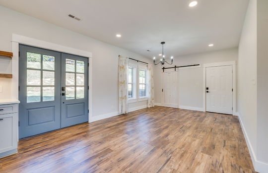 dining space/ eat-in kitchen, luxury vinyl flooring, door to garage, barn door windows, door to exterior
