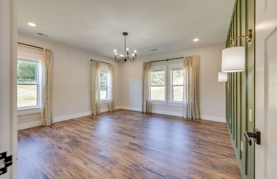 bedroom, luxury vinyl flooring, board and batten feature wall, sconces, chandelier, windows