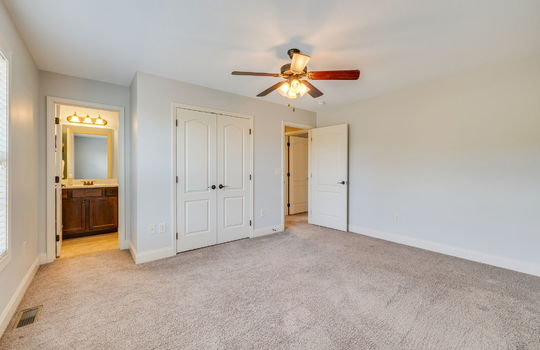 second bedroom, closet, carpet, ceiling fan, door to ensuite bathroom