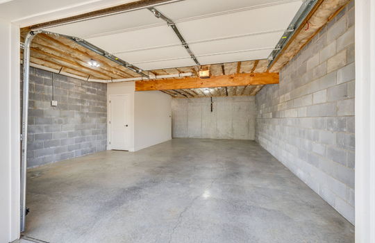 basement/garage, block walls, concrete flooring, garage door