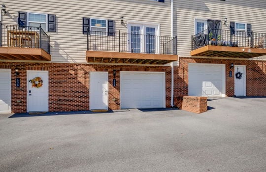 back of townhomes, private balconies, garage door, ground level entry door, vinyl siding, other townhomes