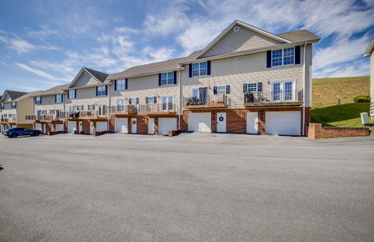back of townhomes, private balconies, garage door, ground level entry door, vinyl siding, other townhomes