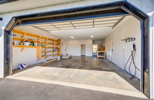 garage, concrete flooring, interior entry doors, exterior door, built-in shelving