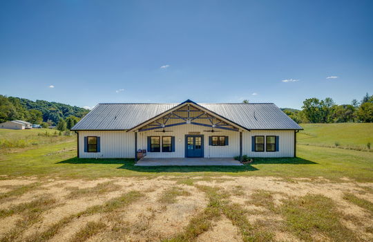 back yard, porch swing, covered back porch, entry door, metal siding, metal roof, outdoor ceiling fans, mountain views, neighboring homes