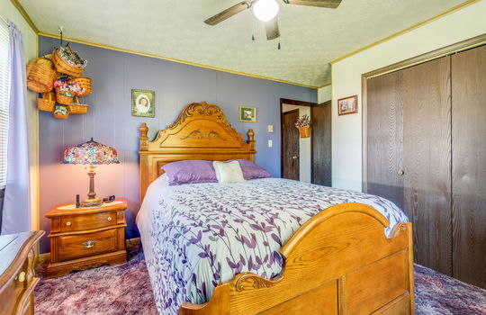 bedroom, carpet, painted paneling walls, closet, ceiling fan, windows