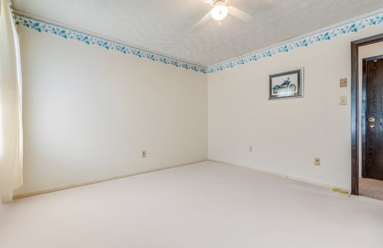 fourth bedroom, digitally altered photo removing furniture, ceiling fan, carpet, door