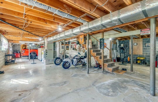 basement, concrete flooring, unfinished, stairs to main level, garage space, block walls