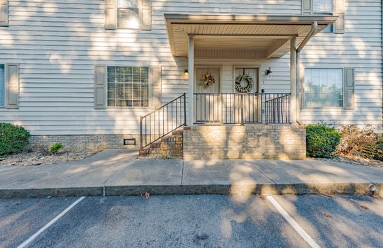 Townhouse, exterior, parking spaces, sidewalk, covered front porch, vinyl siding, front door