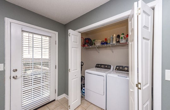 laundry space, laundry closet, washer/dryer hookups, shelves, door to back deck