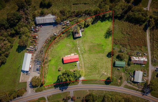aerial photo of home, road, front yard, trees, metal roof, back yard, barn, mountain views, neighboring properties, approximate property outline