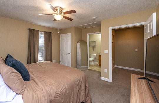 bedroom, carpet, ceiling fan, window, ensuite bathroom, door to hallway