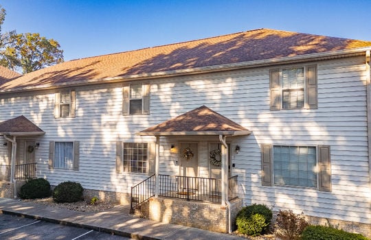 townhouses, parking lot, parking spaces, covered front porch, front porch, vinyl siding, shingle roof