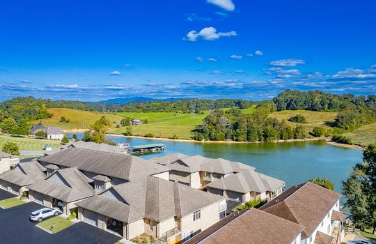 aerial view of townhomes, neighboring properties, Boone lake, trees, mountains