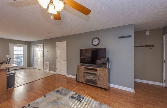 living room, entryway, laminate flooring, ceiling fan