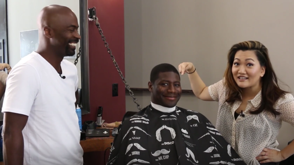 Ji talks to barber Howard Godfrey and former Chicago Bear Jerry Azumah