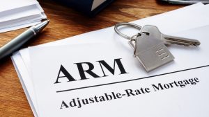 adjustable-rate mortgage printed text on paper and a key and keychain above it