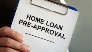 home loan pre-approval printed text on a paper handling by a man