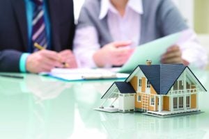 Businessman,Signs,Contract,Behind,Home,Architectural,Model