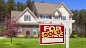 home with sold sign in great neighborhood image