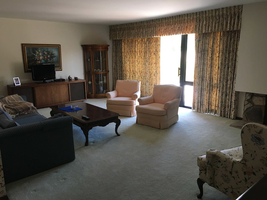 Inherited living room still full of the family's furniture and belongings