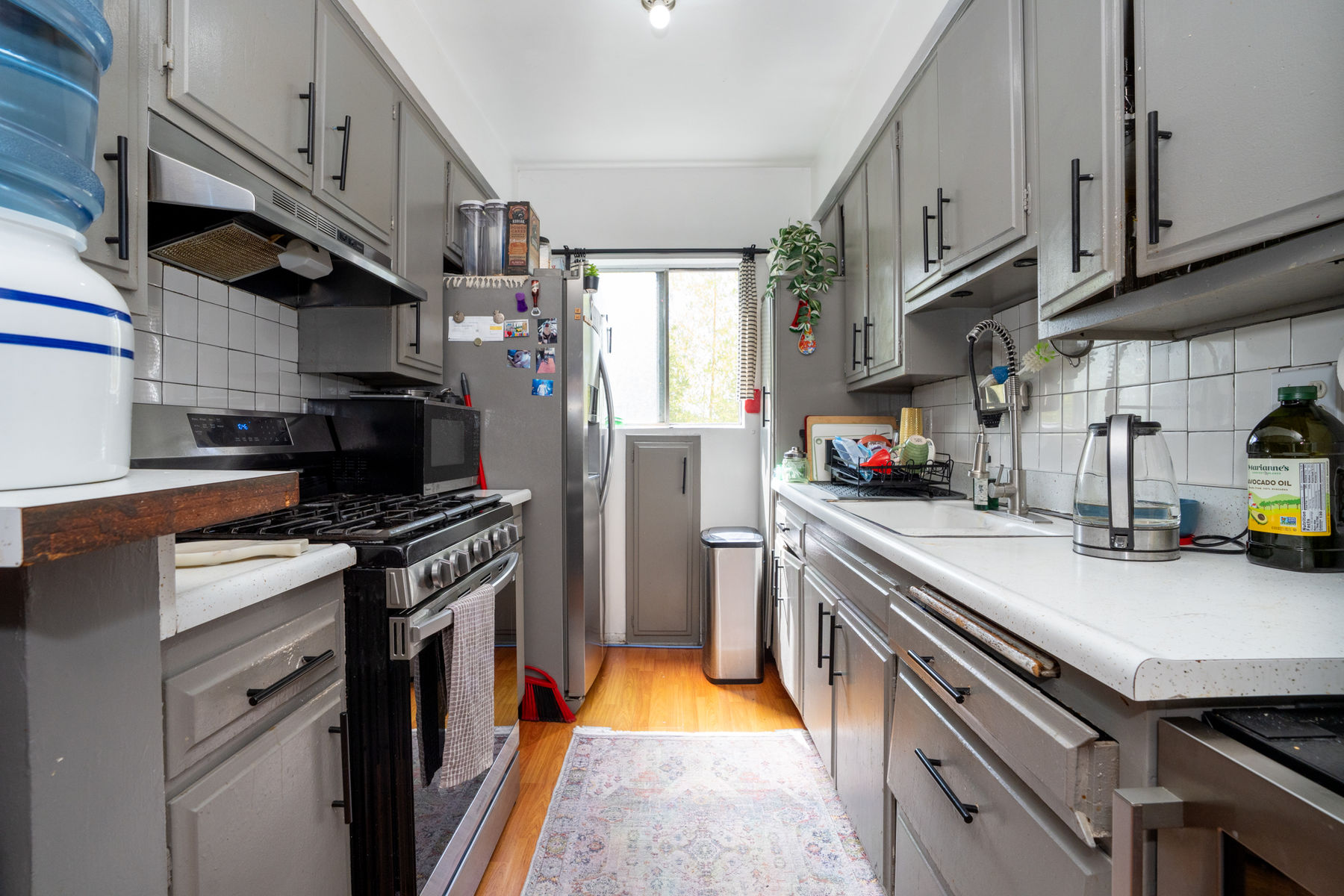 A dated kitchen in an inherited Orange County house, untouched and waiting on a decision.