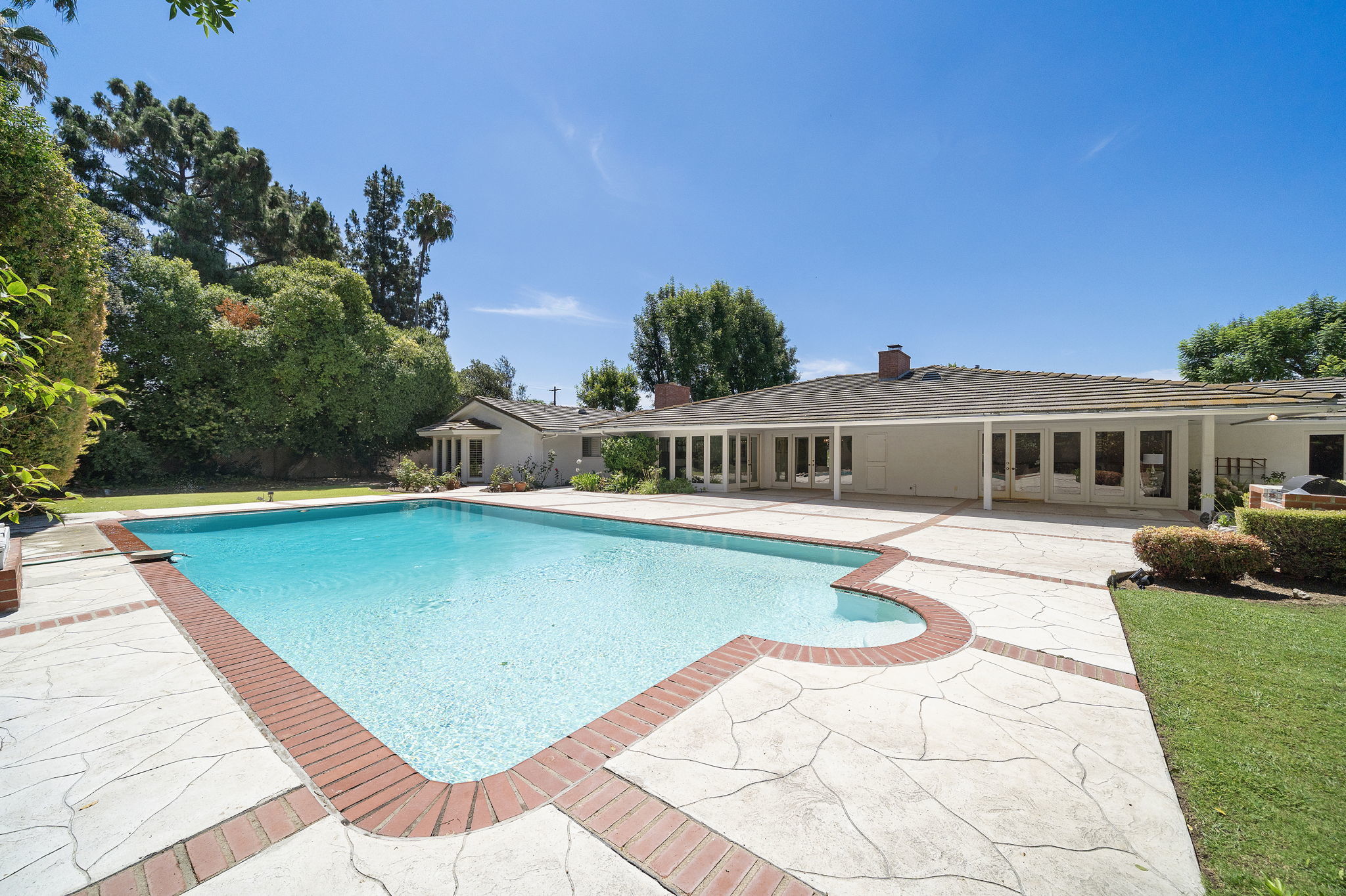 Pool and single story estate home in Orange County