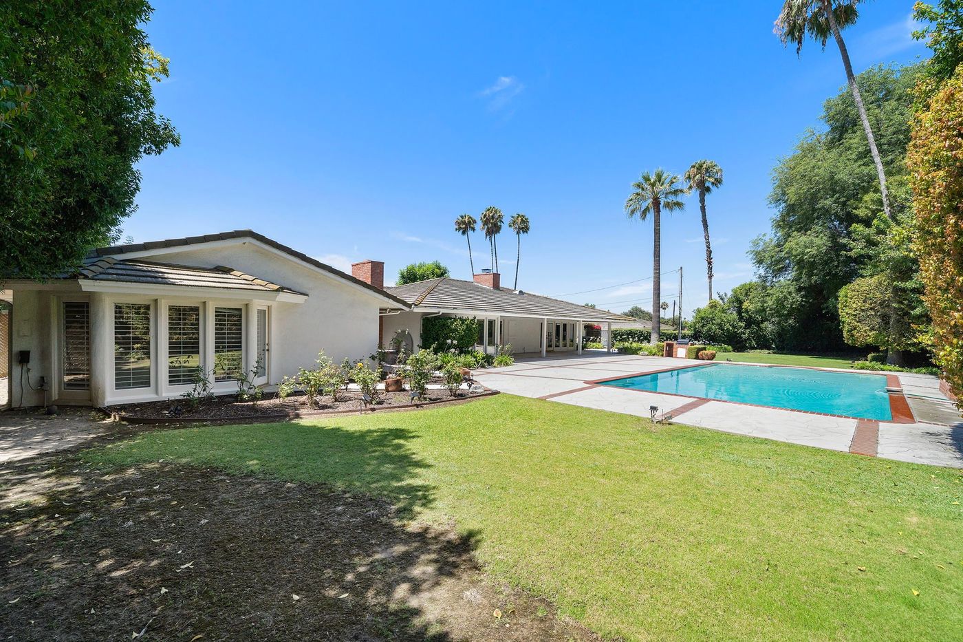 Pool and palms at a Brea trust estate sold by Aragone & Associates