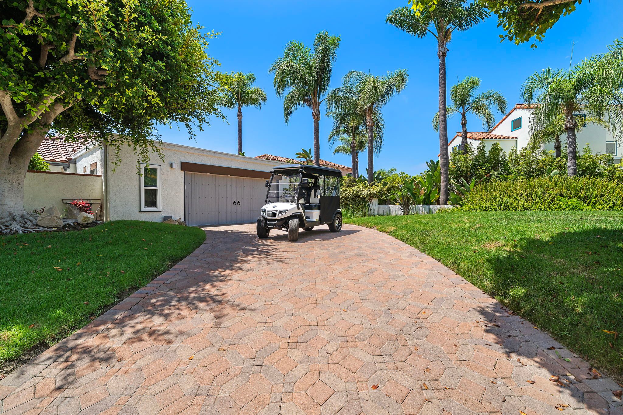 The 2024 street legal golf cart in the driveway at 306 Via Colibri