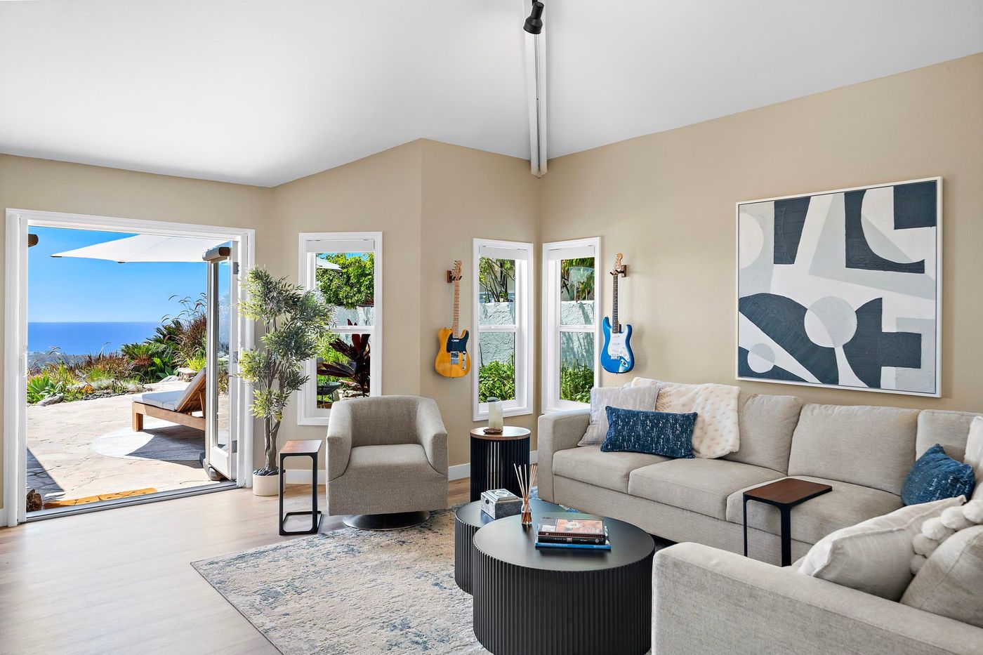 Living room at 306 Via Colibri opening onto the gardens with the coastline beyond