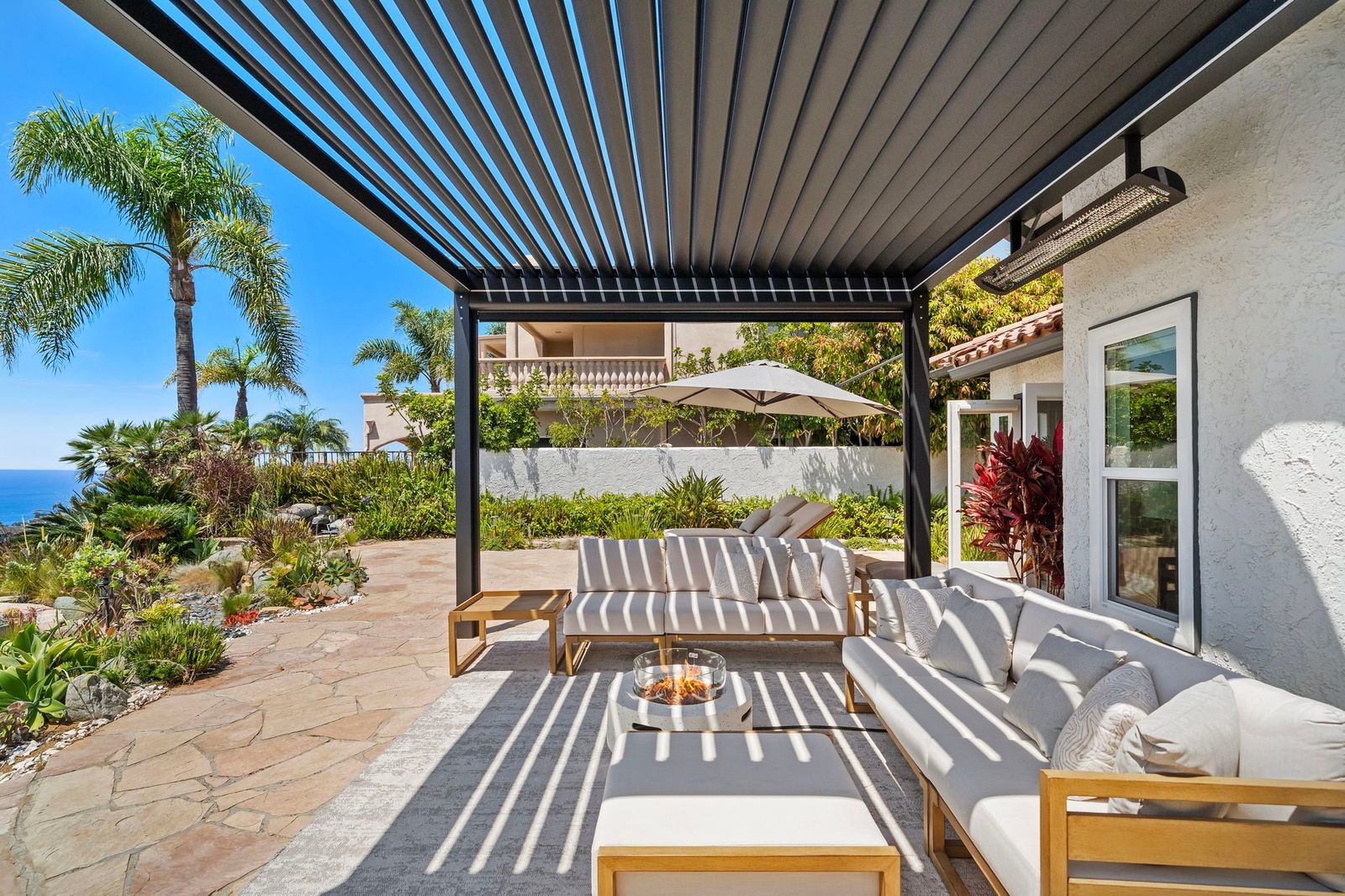 Flagstone terrace under the motorized steel pergola at 306 Via Colibri