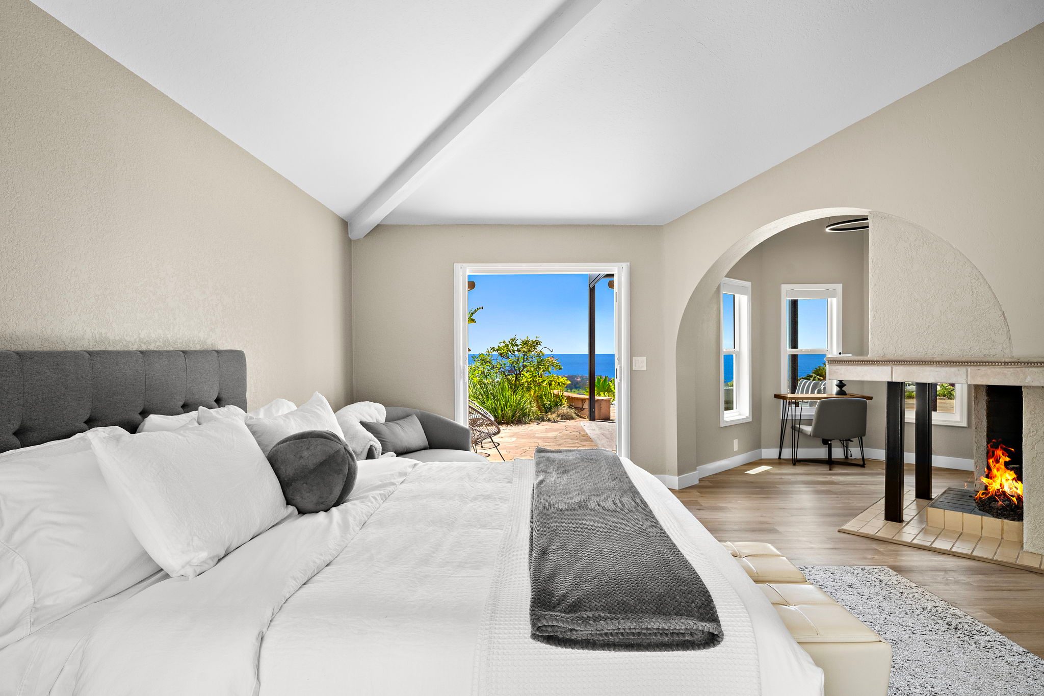Primary suite at 306 Via Colibri with a fireplace and an ocean view